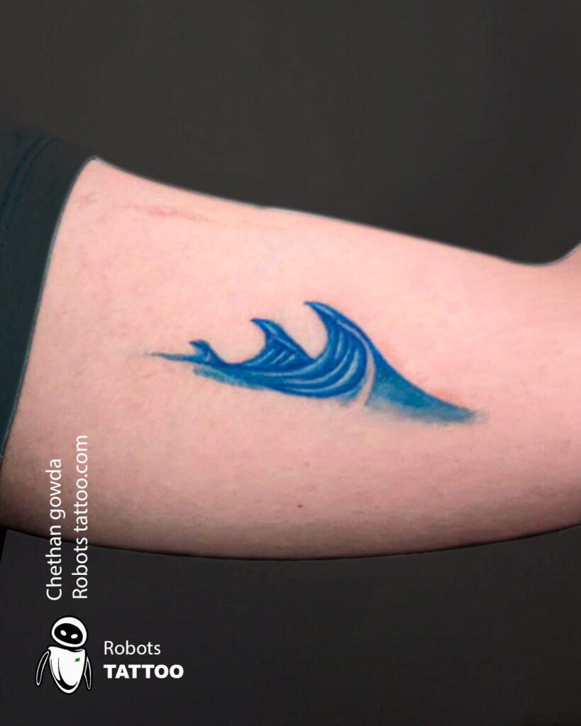 Blue waves tattoo: serene, fluid, natural, symbolizing tranquility and harmony