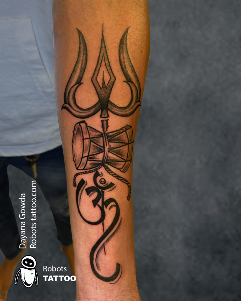 Trishul with damaru with om tattoo done by Dayanagowda @robotstattoo